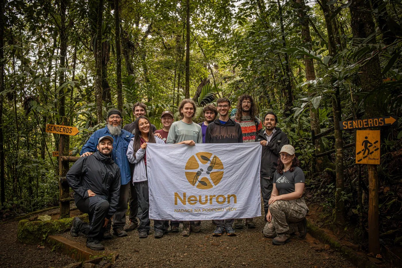 Members of a Neuron Expedition with the foundation's flag in the field