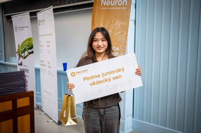 A student holding the board granting her junior scientific dream